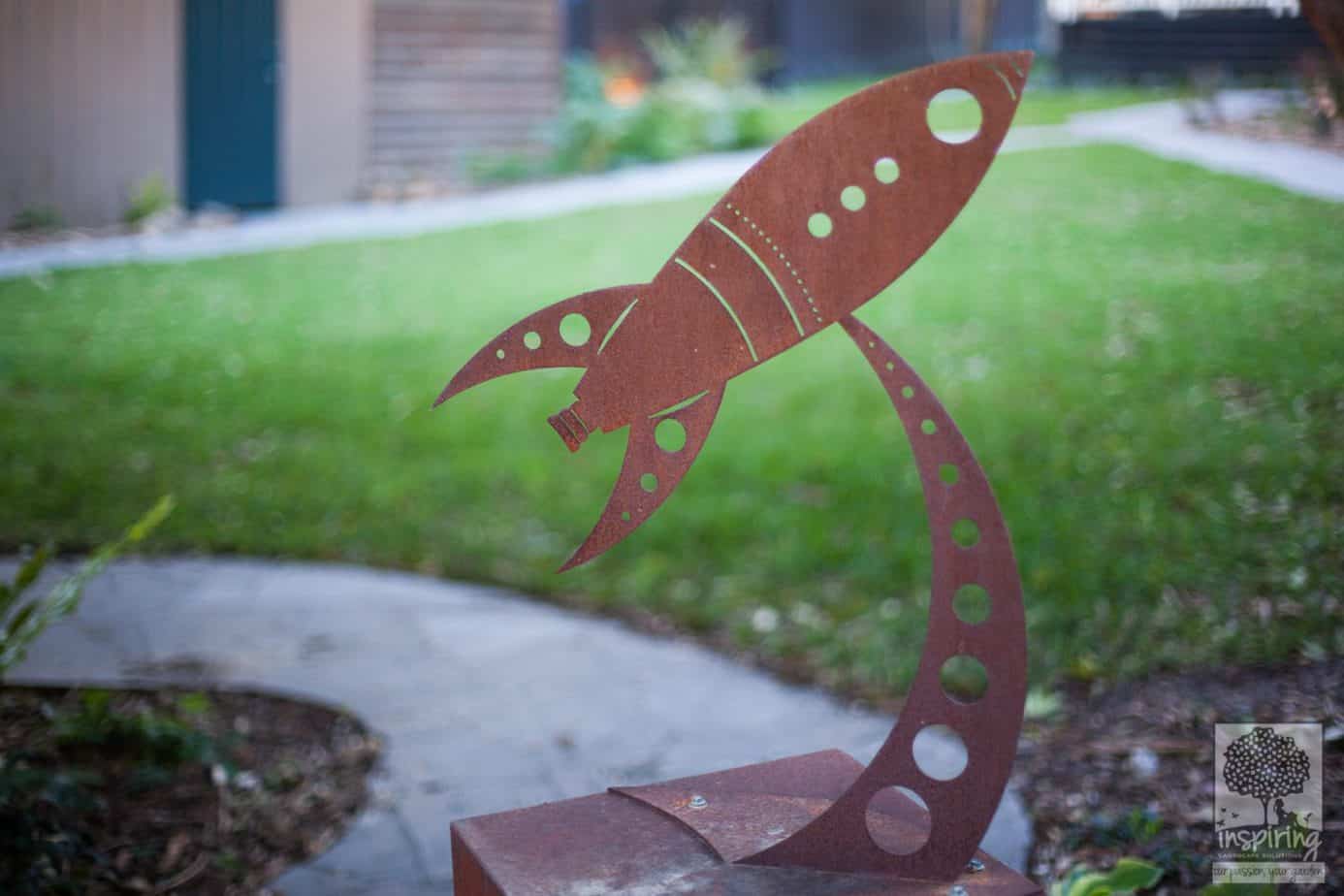 Metal rocket garden sculpture in Blackburn landscape design