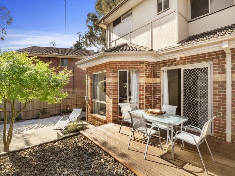 Courtyard garden design makeover showing deck area and outdoor table seating