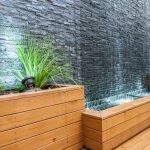 Side view of the wall to wall cascading water feature and retaining beds in Maribyrnong courtyard garden design