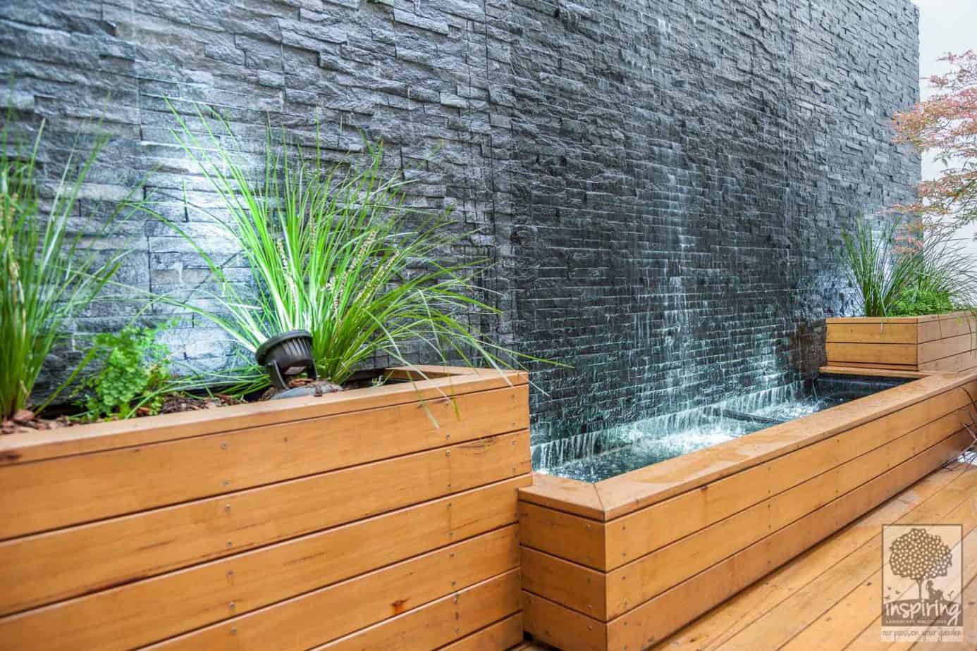 Side view of the wall to wall cascading water feature and retaining beds in Maribyrnong courtyard garden design