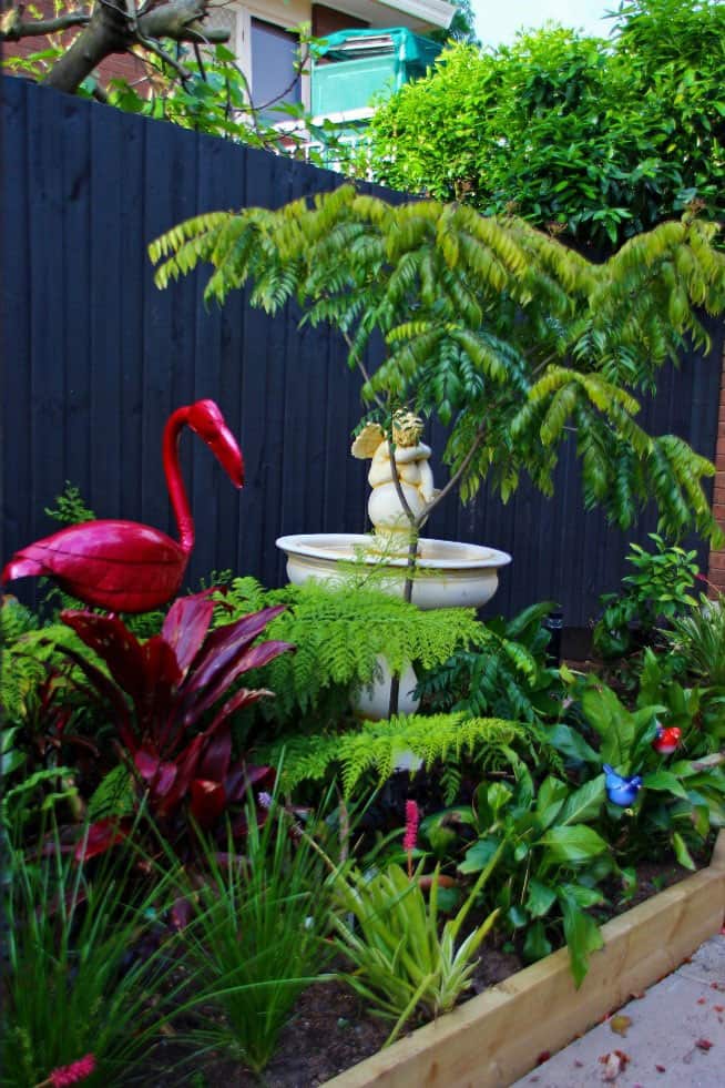Red flamingo garden sculpture used in Vermont South garden design by Parveen Dhaliwal