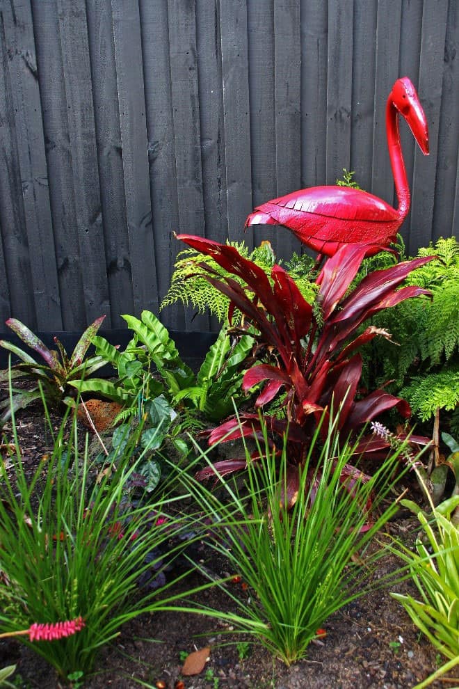 Red flamingo garden sculpture used in Vermont South garden design by Inspiring Landscape Solutions