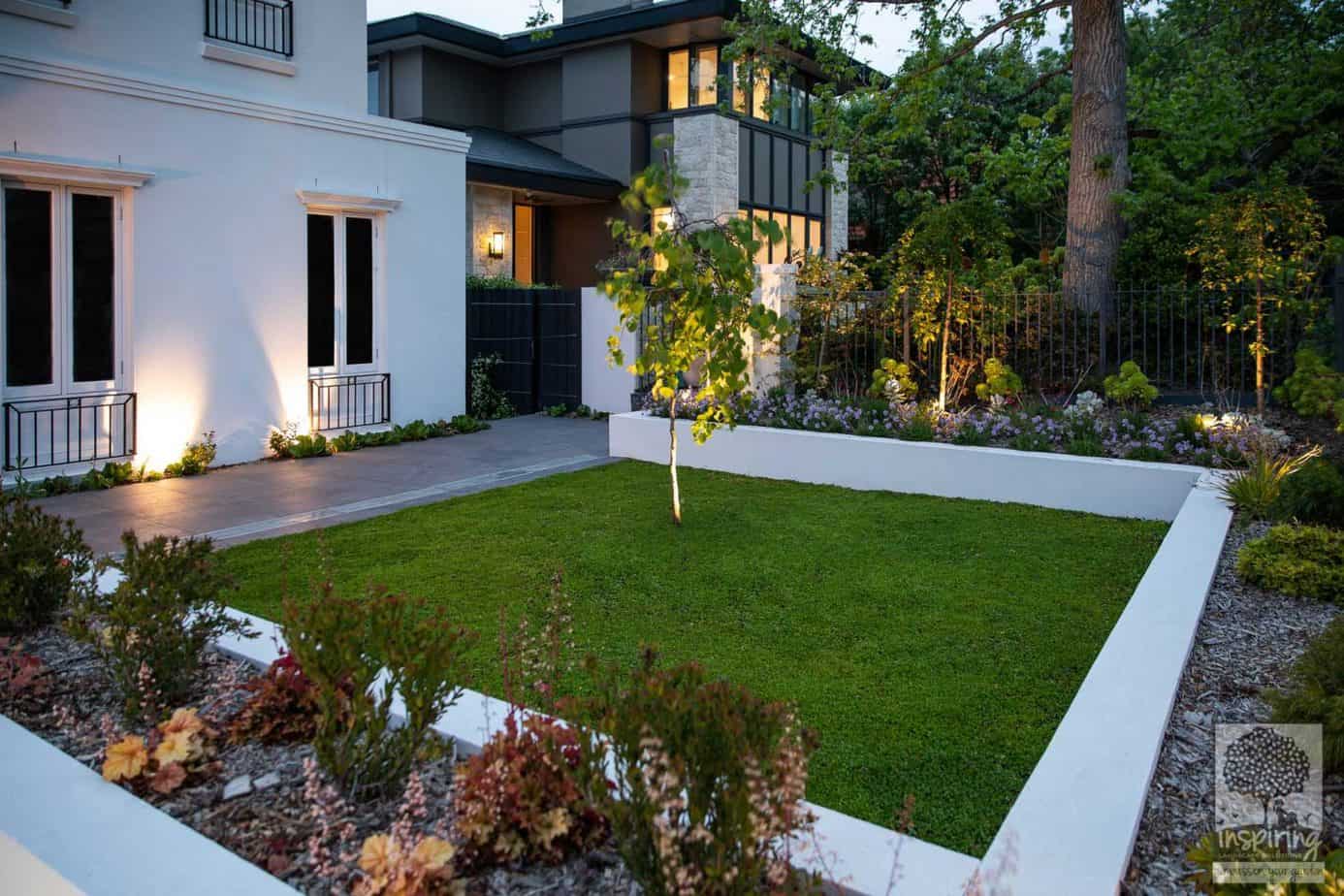 Front garden beds of a new build in Camberwell lit up at night