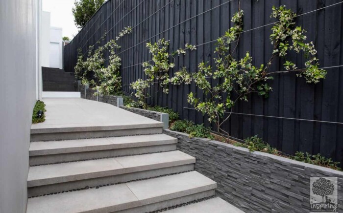 Side stepped path of a new build in Camberwell paved with bluestone pavers with narrow garden beds