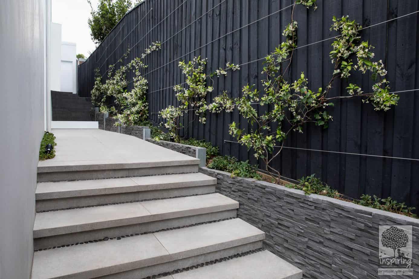 Side stepped path of a new build in Camberwell paved with bluestone pavers with narrow garden beds
