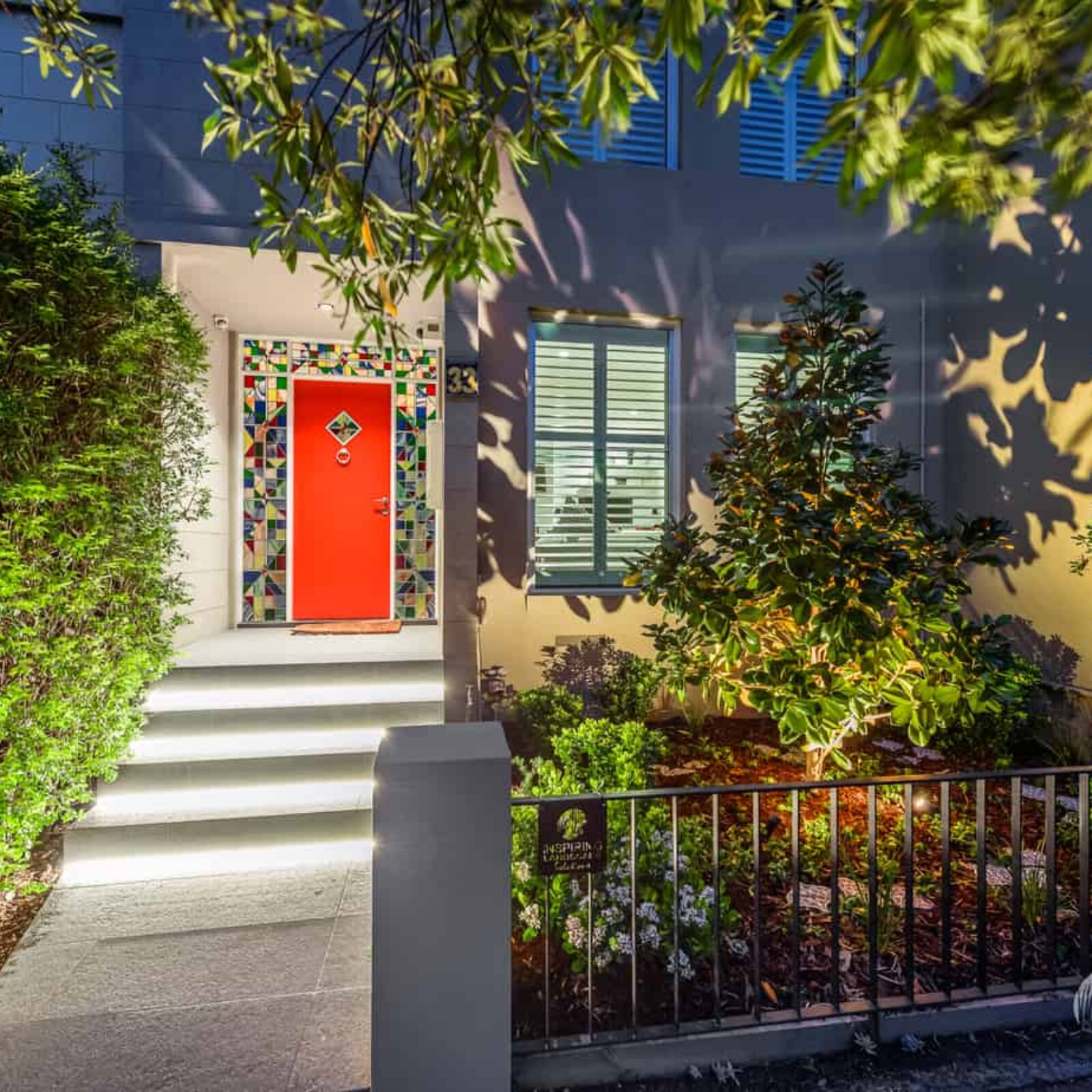 Dramatic lighting effect of highlighting magnolia tree and other shrubs in Hawthorn East front garden design