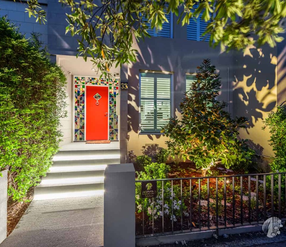 Dramatic lighting effect of highlighting magnolia tree and other shrubs in Hawthorn East front garden design