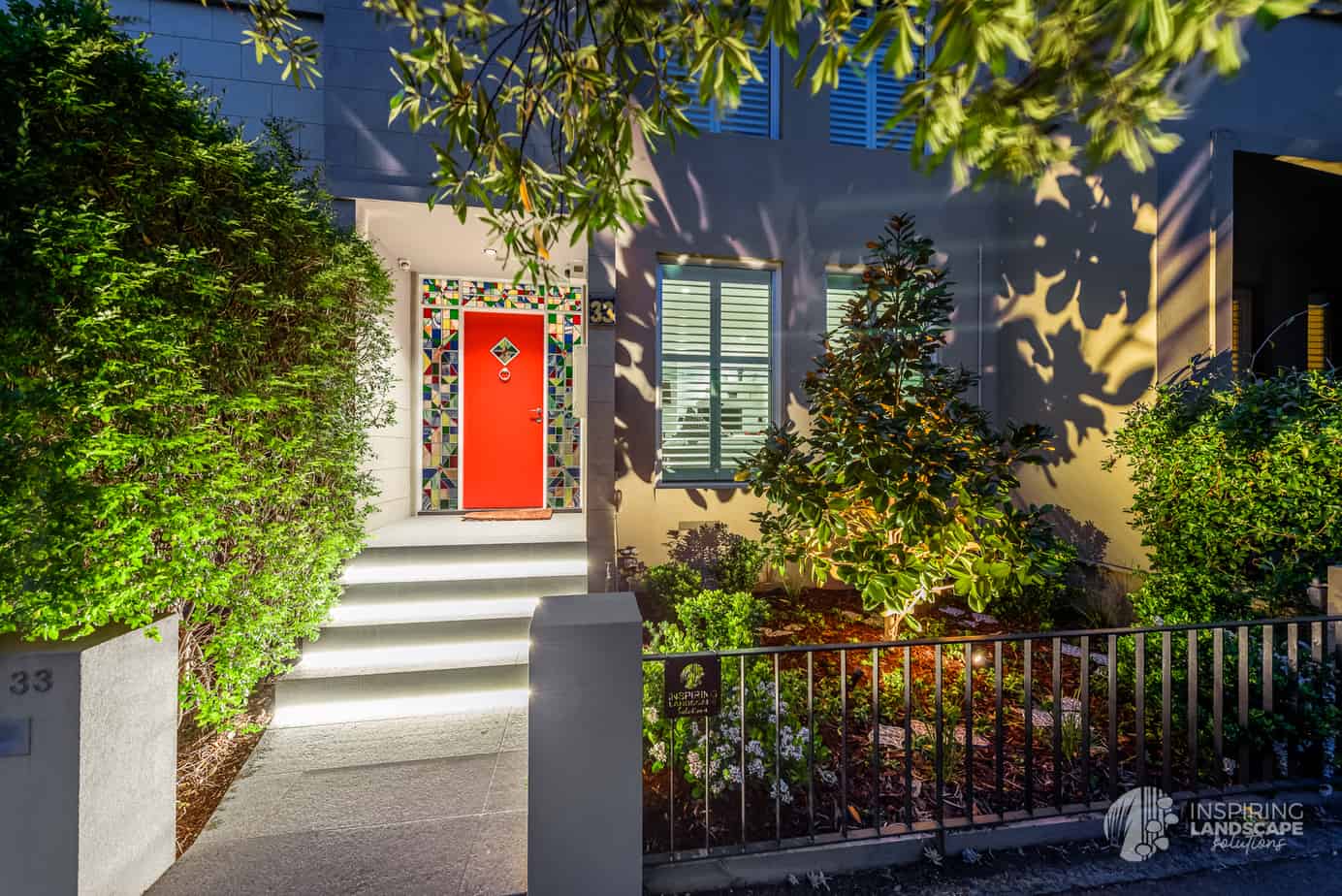 Dramatic lighting effect of highlighting magnolia tree and other shrubs in Hawthorn East front garden design