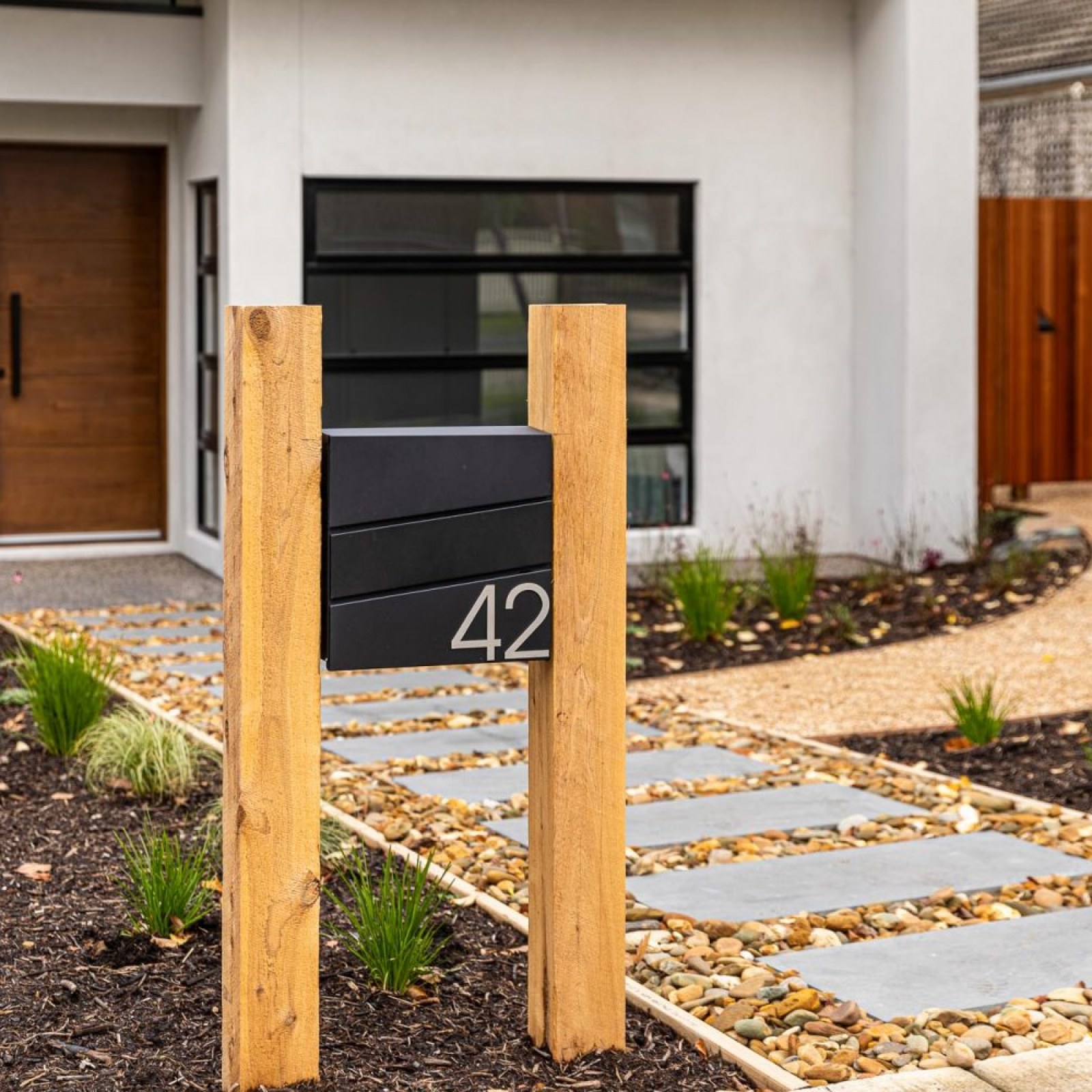 View of front entry stepper path from the street in Burwood landscape design by Parveen Dhaliwa