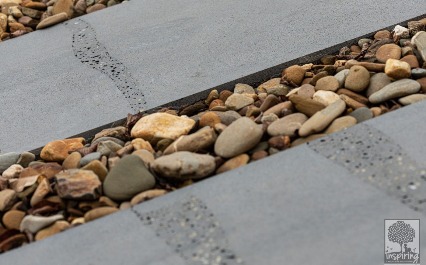 Close up of bluestone paving and oversized pebbles in Burwood landscape design by Parveen Dhaliwal