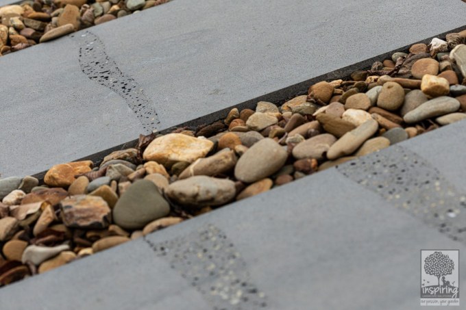 Close up of bluestone paving and oversized pebbles in Burwood landscape design by Parveen Dhaliwal
