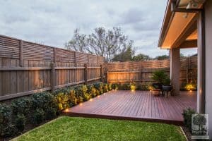 Backyard merbau decking in Ashburton garden design with garden lighting