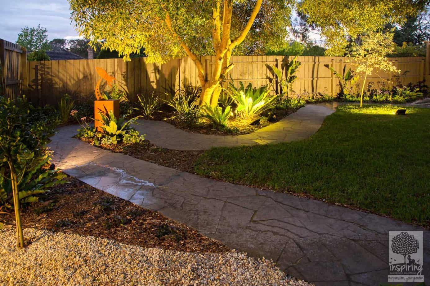 Crazy paved path in Blackburn garden design with rocket metal sculpture