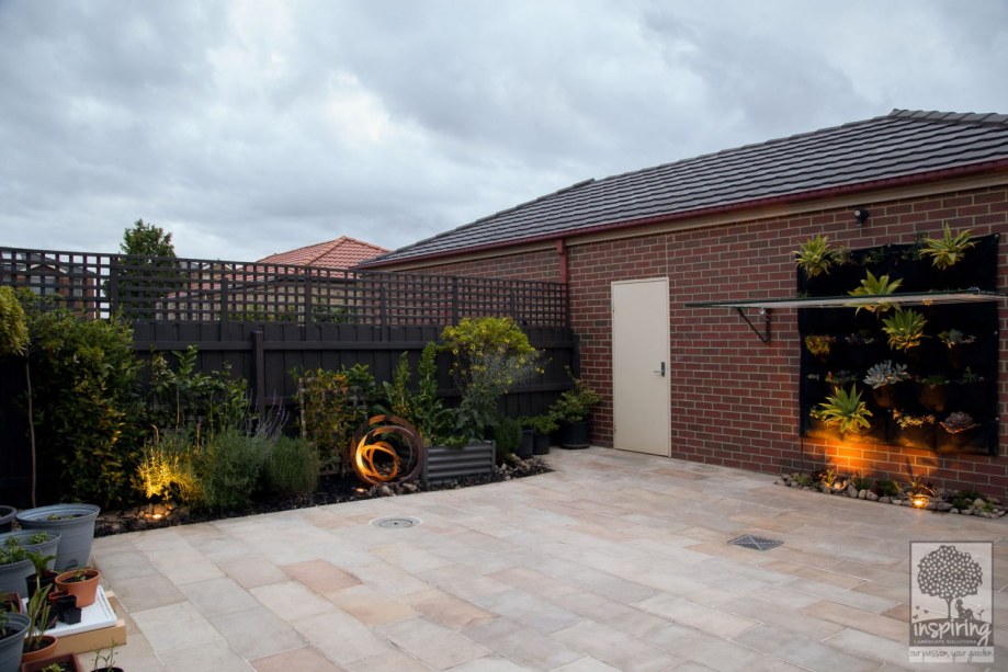 Courtyard garden design with sandstone paving and edible planting
