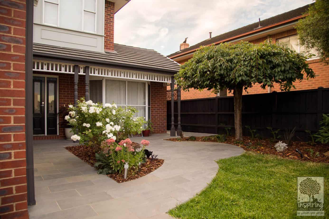 Closeup view of front garden in Kew garden design with mixed planting of edibles, exotics and perennials