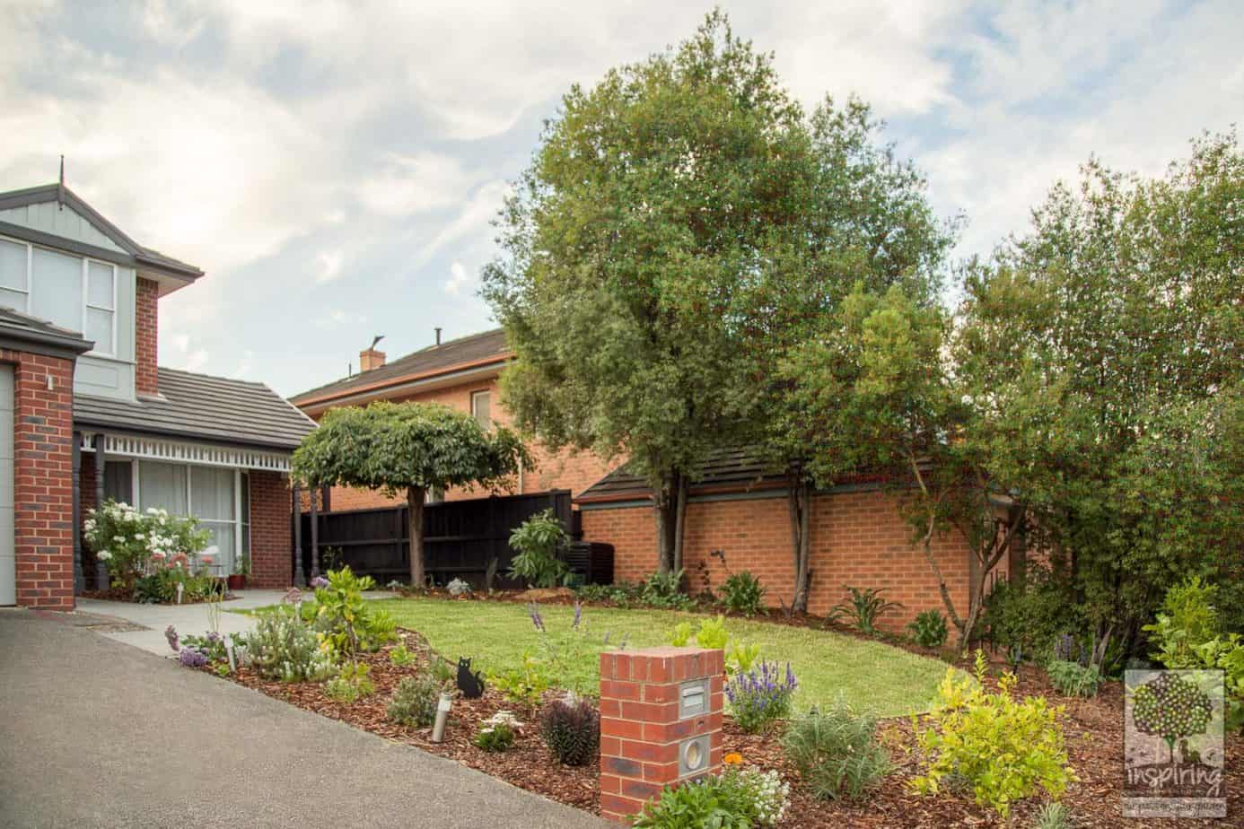 Side view of front garden in Kew garden design with mixed planting of edibles, exotics and perennials