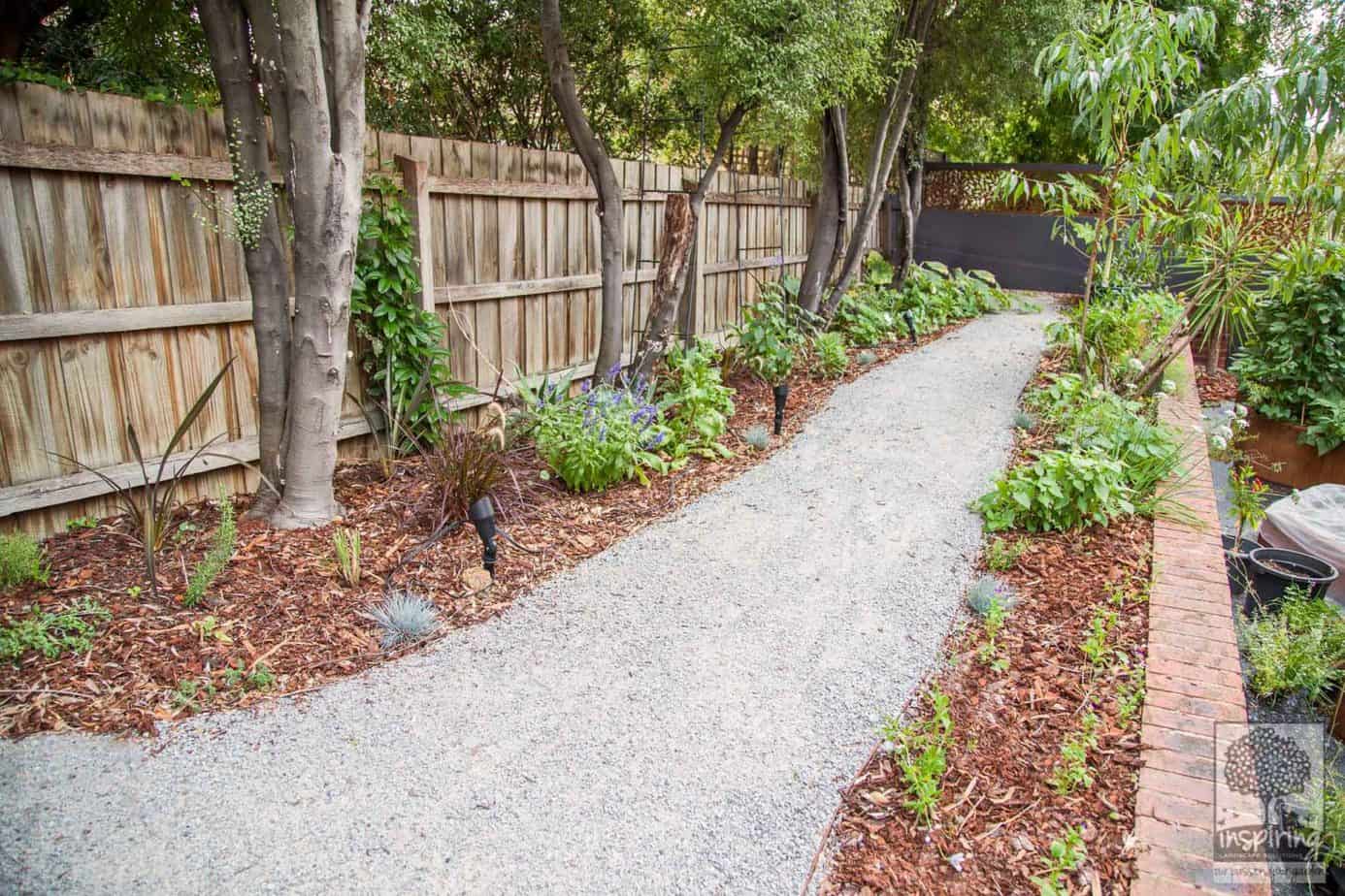 Rear garden path with edibles and perennial planting in Kew design