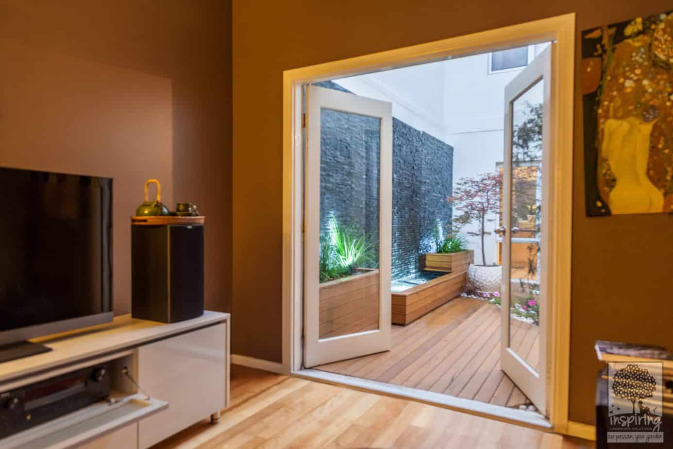 View of courtyard with wall to wall water feature from the family lounge