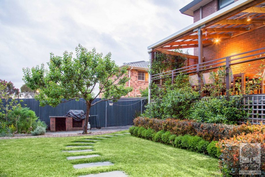 View of backyard grassed area, deck and vegetable patch in Vermont South garden design by Parveen Dhaliwa