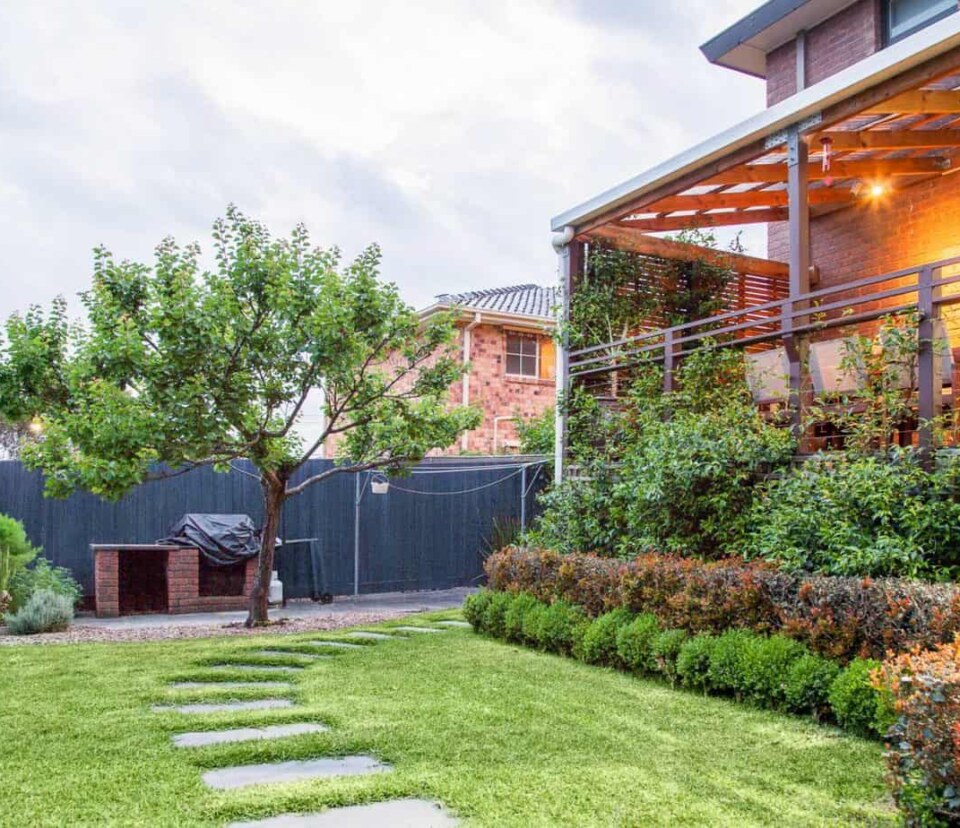 View of backyard grassed area, deck and vegetable patch in Vermont South garden design by Parveen Dhaliwa