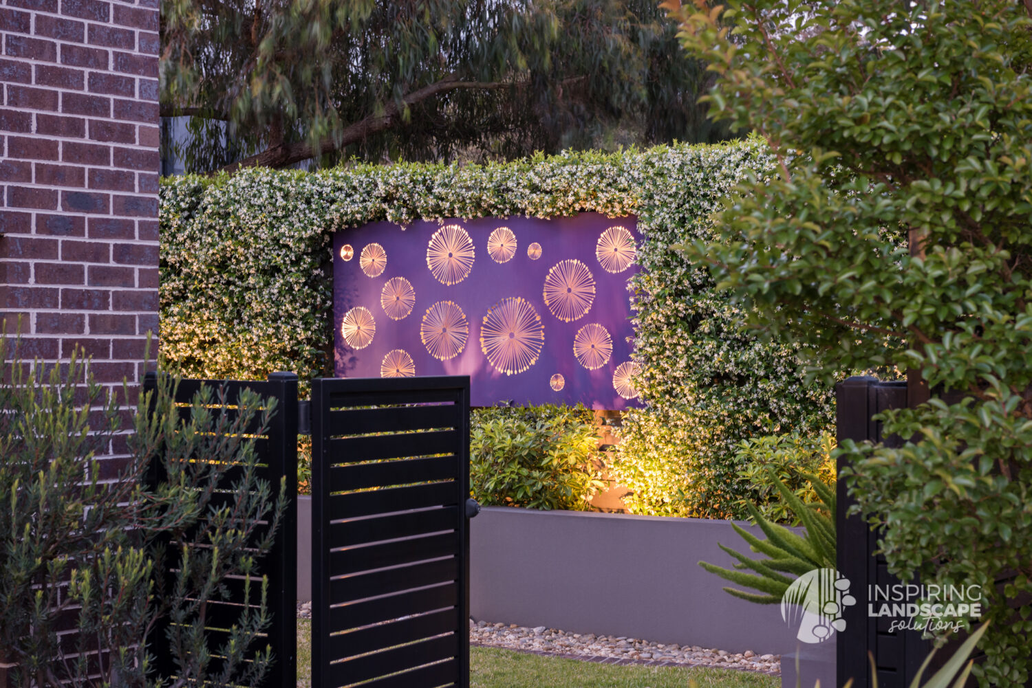 Purple metal screen lit up in Wantirna South garden