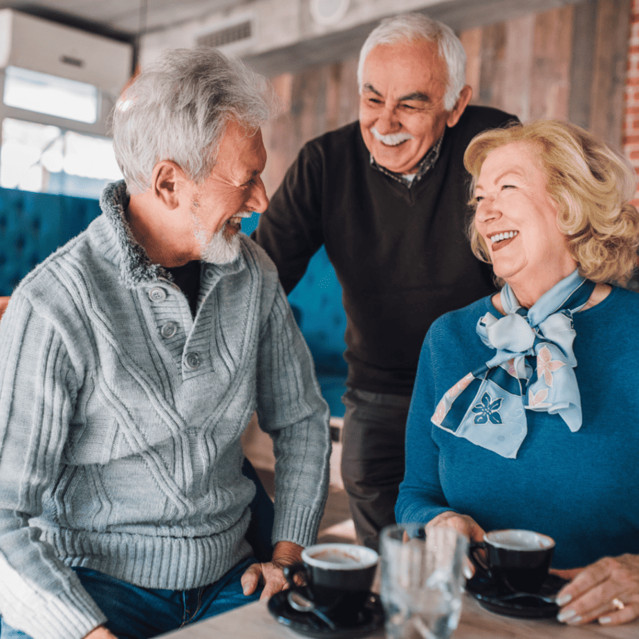 Group of adults having a laugh while enjoying each other's company.