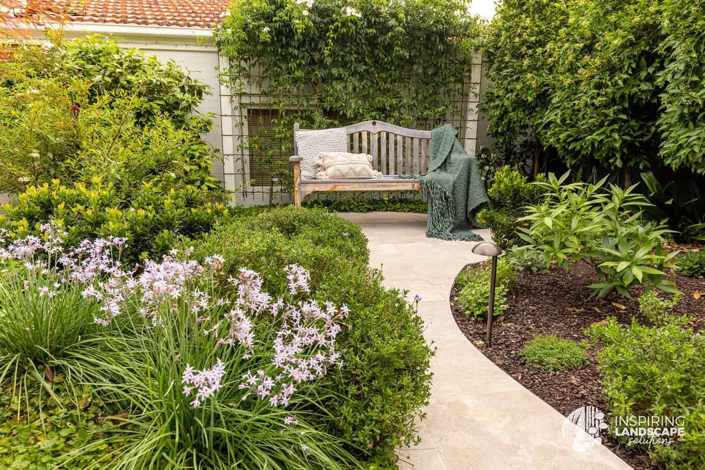 Garden beds surrounding bench seat in Berwick landscape design