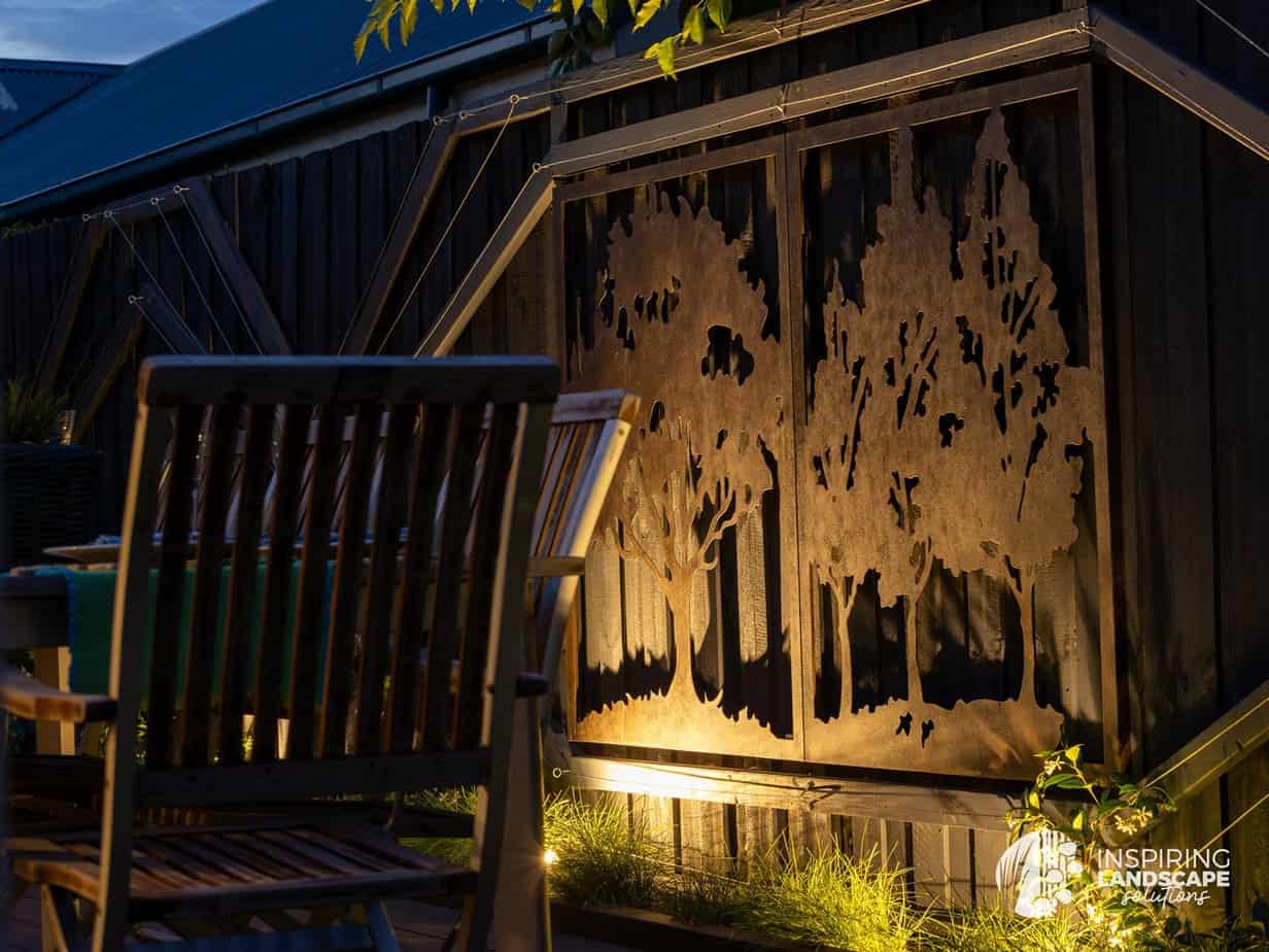 View of metal artwork on fencing, from kitchen window in Highett garden design